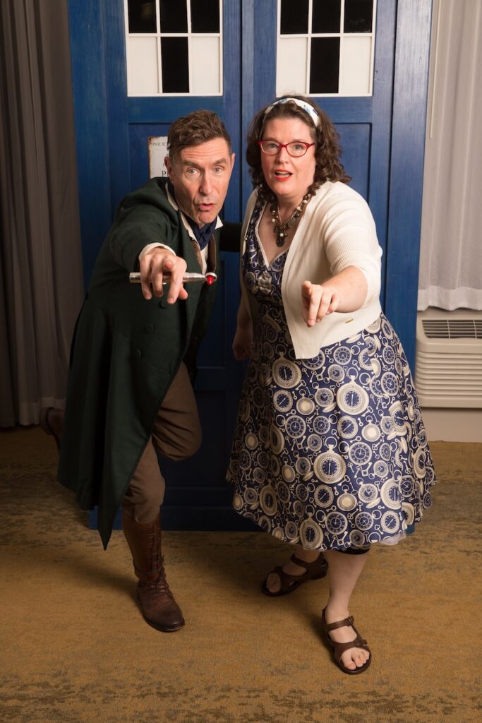 Paul McGann as the Eighth Doctor with Nancy Norbeck in front of a TARDIS